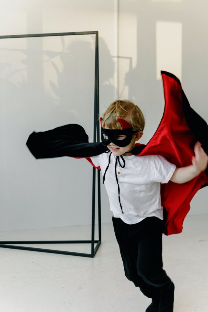 Child Wearing a Mask and a Cape